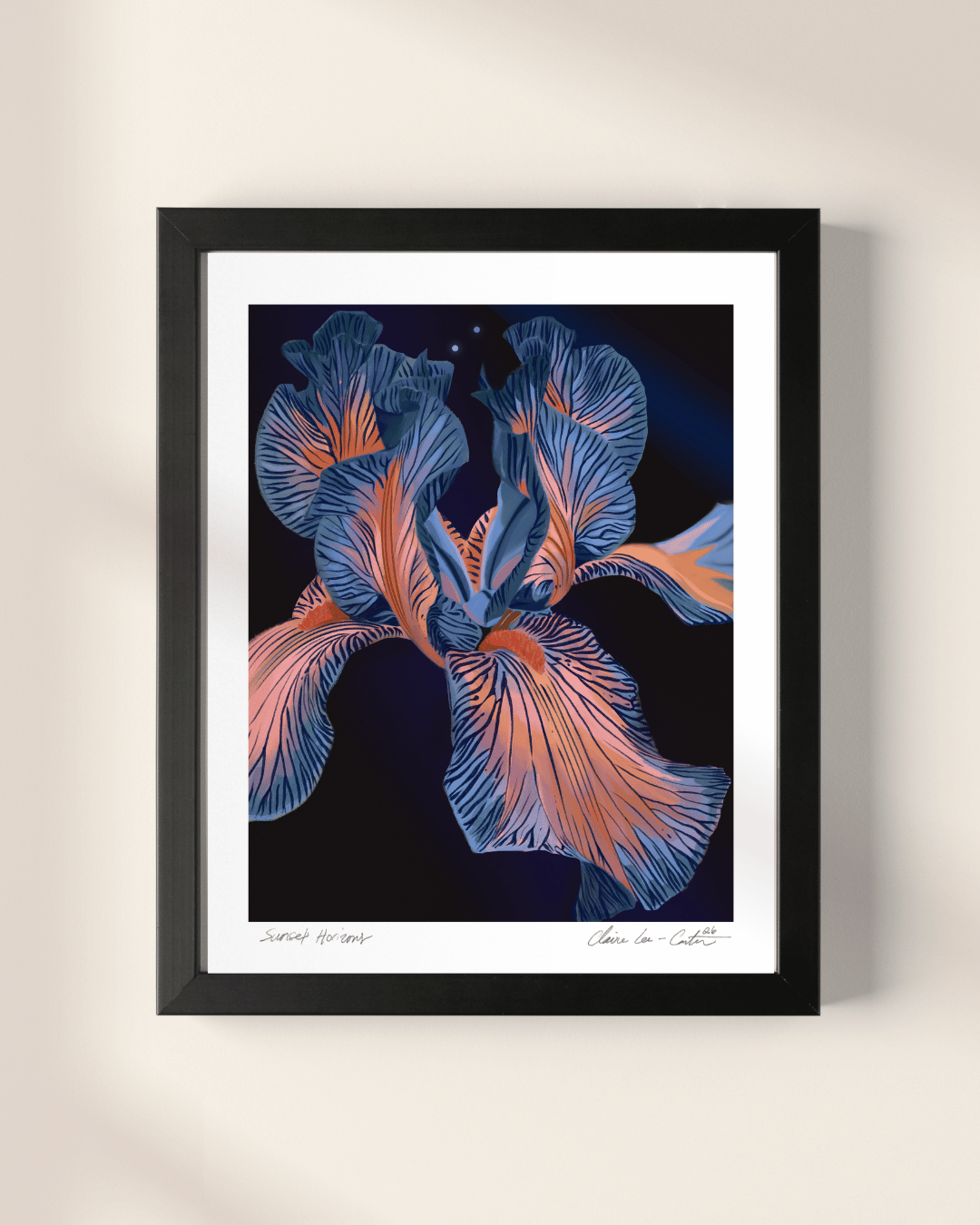 Framed artwork of a blue and orange floral design on a beige wall.