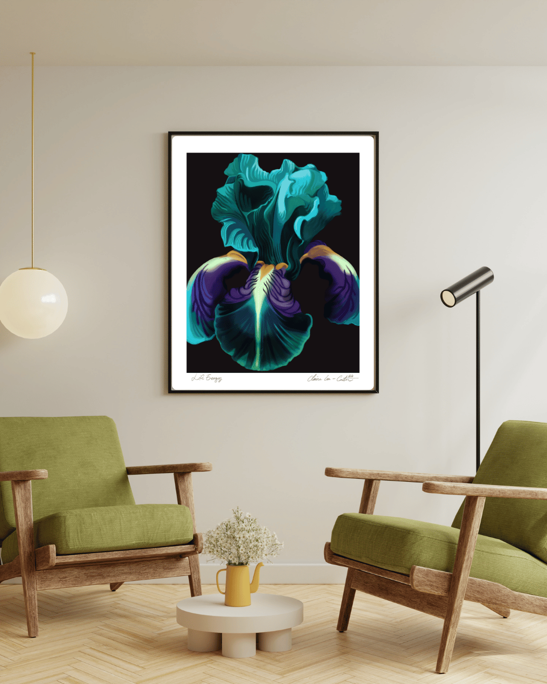 Framed artwork of a colorful green, purple, and orange iris flower with a black background and a white border on a beige wall in a modern living room with green chairs and a small table. 