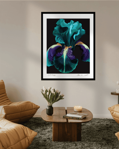 Framed artwork of a colorful green, purple, and orange iris flower with a black background and a white border on a beige wall in a trendy living room with hipster chairs and vase of white tulips on a coffee table. 