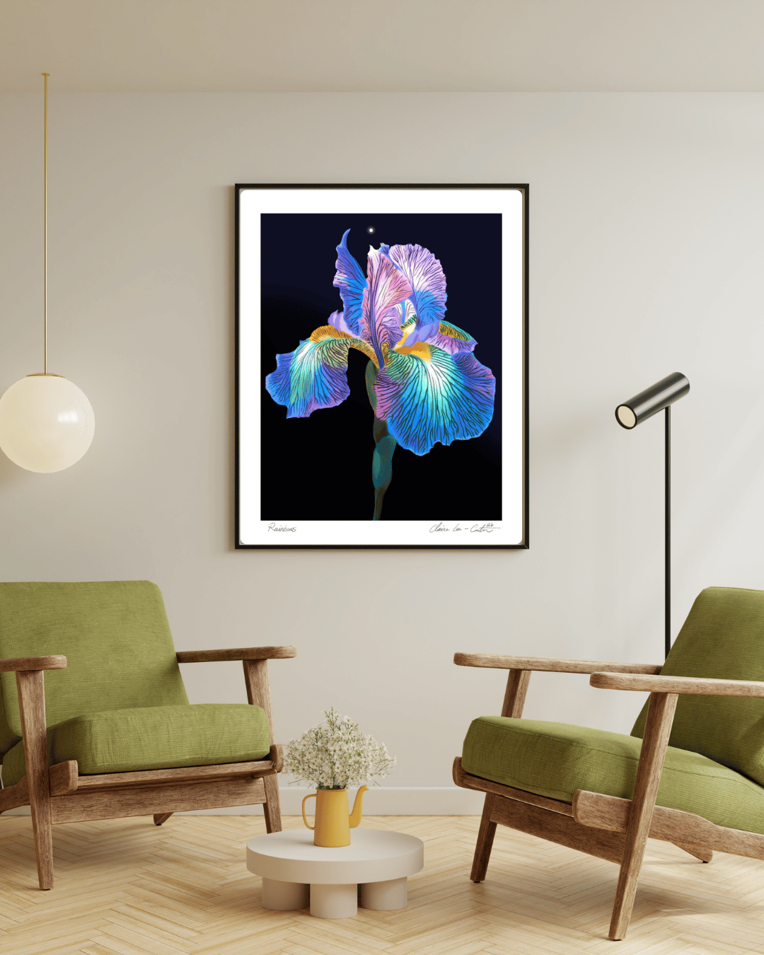 Framed artwork of a rainbow colored iris flower on a beige wall in a modern living room with green chairs and a small table. 